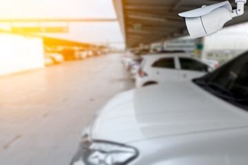 Closeup CCTV camera in the outdoor cars park with a beautiful sunlight.