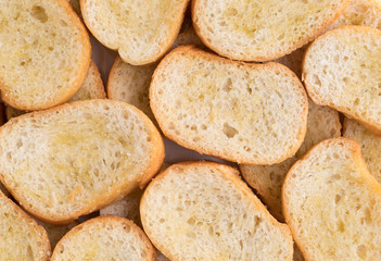 Crostini dabbed with olive oil close view