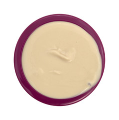Overflowing bowl of coffee flavored yogurt isolated on a white background.