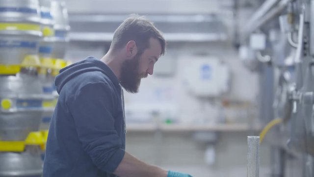  Worker in a brewery testing beer & checking quality of the product. 
