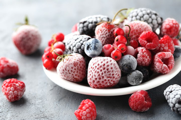 Frozen berries on a black wooden table