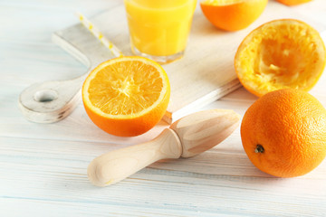 Citrus fruits with juicer on a blue wooden table