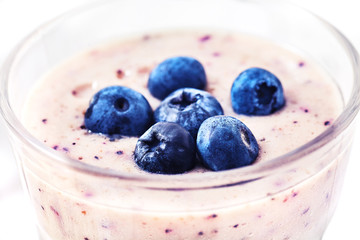 Close-up shot of blueberry smoothie with berries in glass