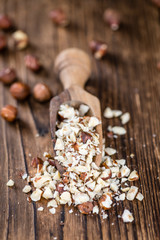 Wooden table with chopped Hazelnuts