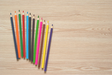 Fototapeta premium Pencils, crayons and notebook on a desk.