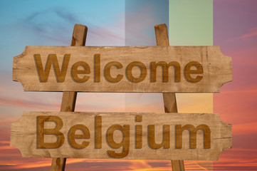 Welcome to  Belgium sing on wood background with blending national flag