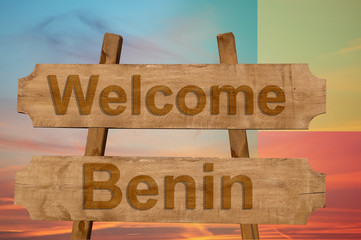 Welcome to  Benin sing on wood background with blending national flag