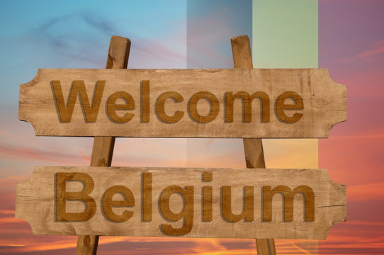 Welcome to  Belgium sing on wood background with blending national flag