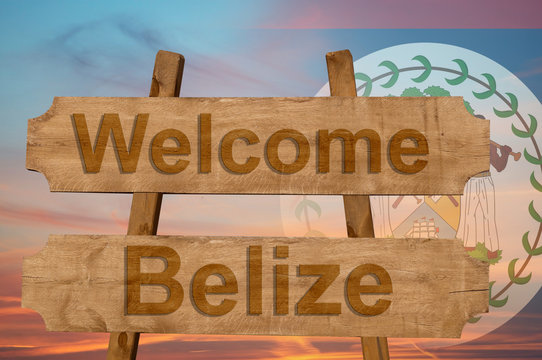 Welcome to  Belize sing on wood background with blending national flag