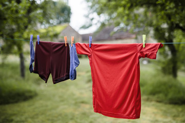 House of little football player. Boy&rsquo;s sport outfit on drying line outdoor,