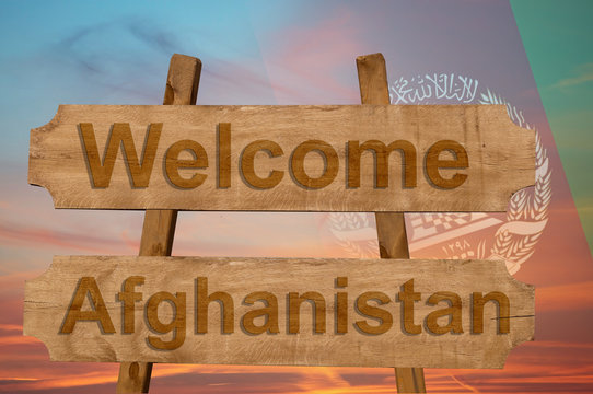 Welcome to Afghanistan sing on wood background with blending national flag