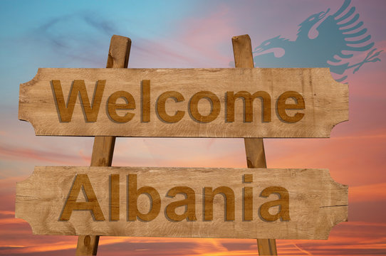 Welcome to Albania sing on wood background with blending national flag