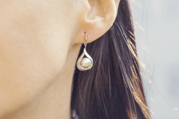 Woman ear wearing beautiful luxury earring