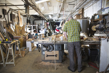 Father and daughter woodworking in workshop