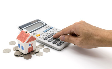 House and calculator and hand on white background