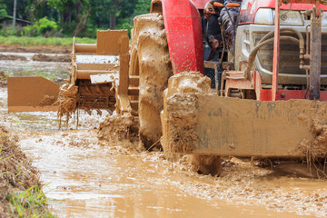 Tractor plowing farm field in preparation for season planting