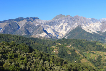 Fototapeta na wymiar Panoramic view of the Alpi Apuane mountain chain with white marble quarries in Tuscany, Italy.