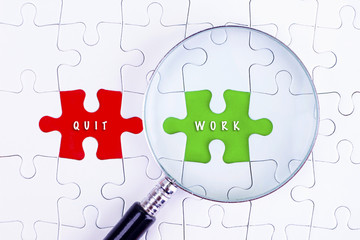 BUSINESS CONCEPT - Magnifying glass on missing puzzle   with a quit work word