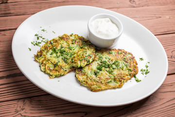 Pumpkin pancakes on white plate with sauce