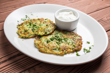 Pumpkin pancakes on white plate with sauce