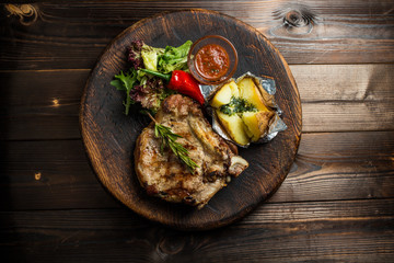 pork loin on board with vegetables gourmet