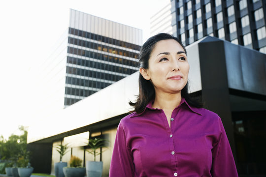 Asian businesswoman walking outdoors