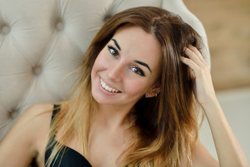 Female portrait of cute lady in black bra indoors. Close up beautiful sexy model girl in elegant pose. Closeup beauty brunette woman with hairstyle