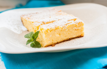 cottage cheese casserole piece sprinkled with powdered sugar on