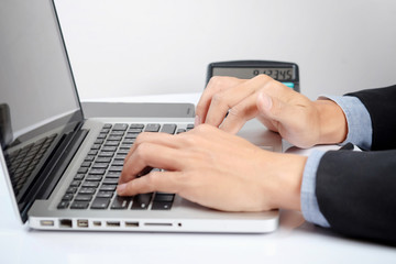 Business man hands typing on a PC or laptop keyboard
