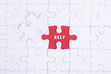 Missing white puzzle with HELP  word and copyspace area.
