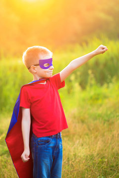 Child playing super hero and super man