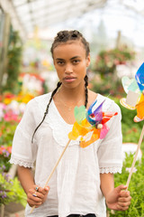 beautiful young woman playing with pinwheel