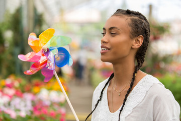 beautiful young woman playing with pinwheel