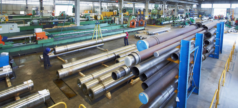 Workers and piping in factory