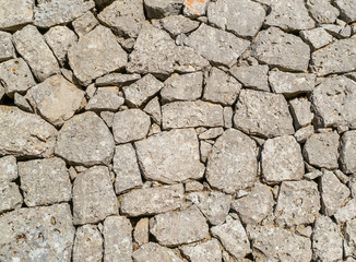 Traditional wall of stones built without lime. Dry stone wall.