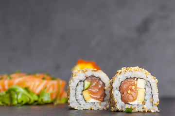 Sushi rolls on black plate