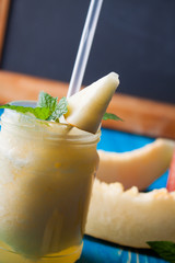 Smoothies Melon on blue wooden boards