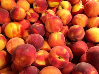 Close up of a big box of peaches at the super market