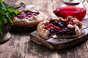 Blueberry,cherry,raspberry and blackcurrant galette on w wooden background.