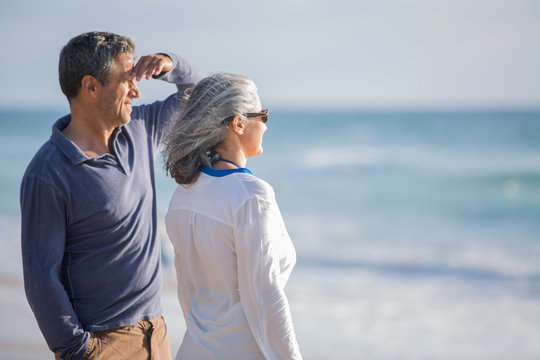 Mid Aged Couple Laying Out On The Beach