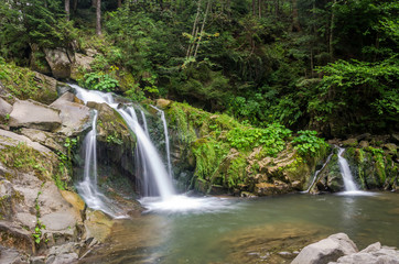 Obraz premium Mountain river with waterfall and rocks at national park in the Skole Beskids near Lviv