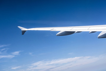 wing of aircraft in blue sky