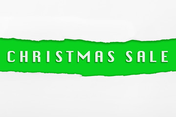 Torn paper with a CHRISTMAS SALE word on red background