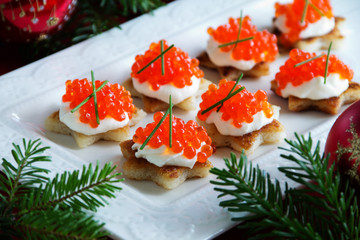 Canape with red caviar for the party, selective focus