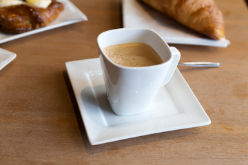 Still life. A cup of coffee and a croissant