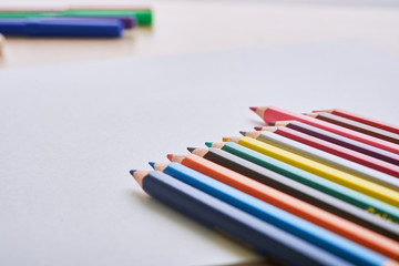 Naklejka premium album and crayons on the desk