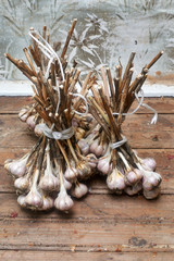 bunch of garlic lying on an old wooden table brown color
