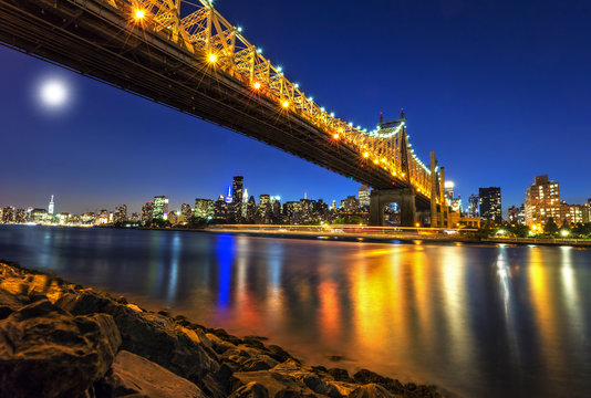 Queensboro Bridge over New York City East River with full moon