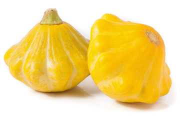 two yellow pattypan squash isolated on white background