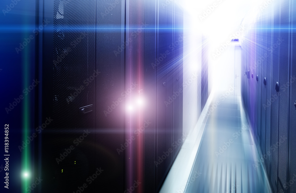 Poster row of server racks with strong light from the end